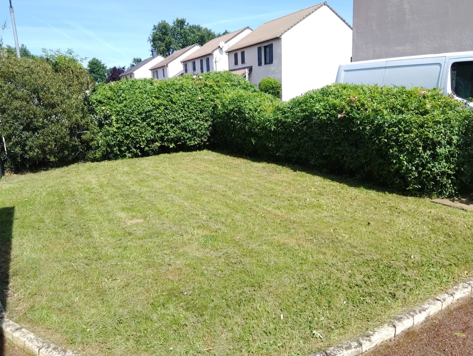 Jardin entretenu par Permapaysage : pelouse tondue et haies taillées